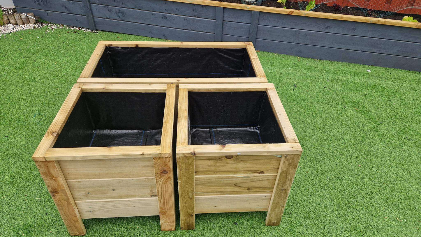 Handcrafted wooden planter set including one large and two medium planters on green grass.