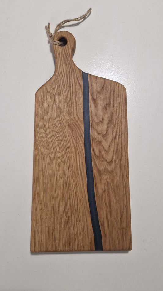 Handmade oak charcuterie board with grey epoxy detail.