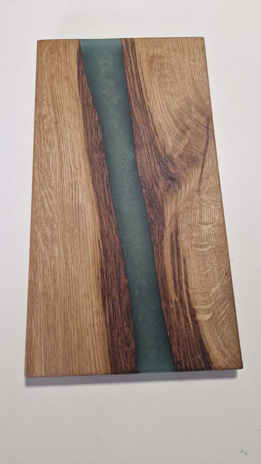 Handmade charcuterie board in oak with green epoxy detailing.