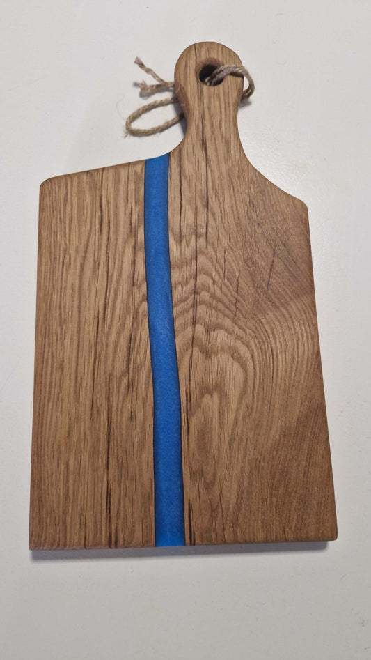 Handmade charcuterie board in oak with blue epoxy accent and handle.