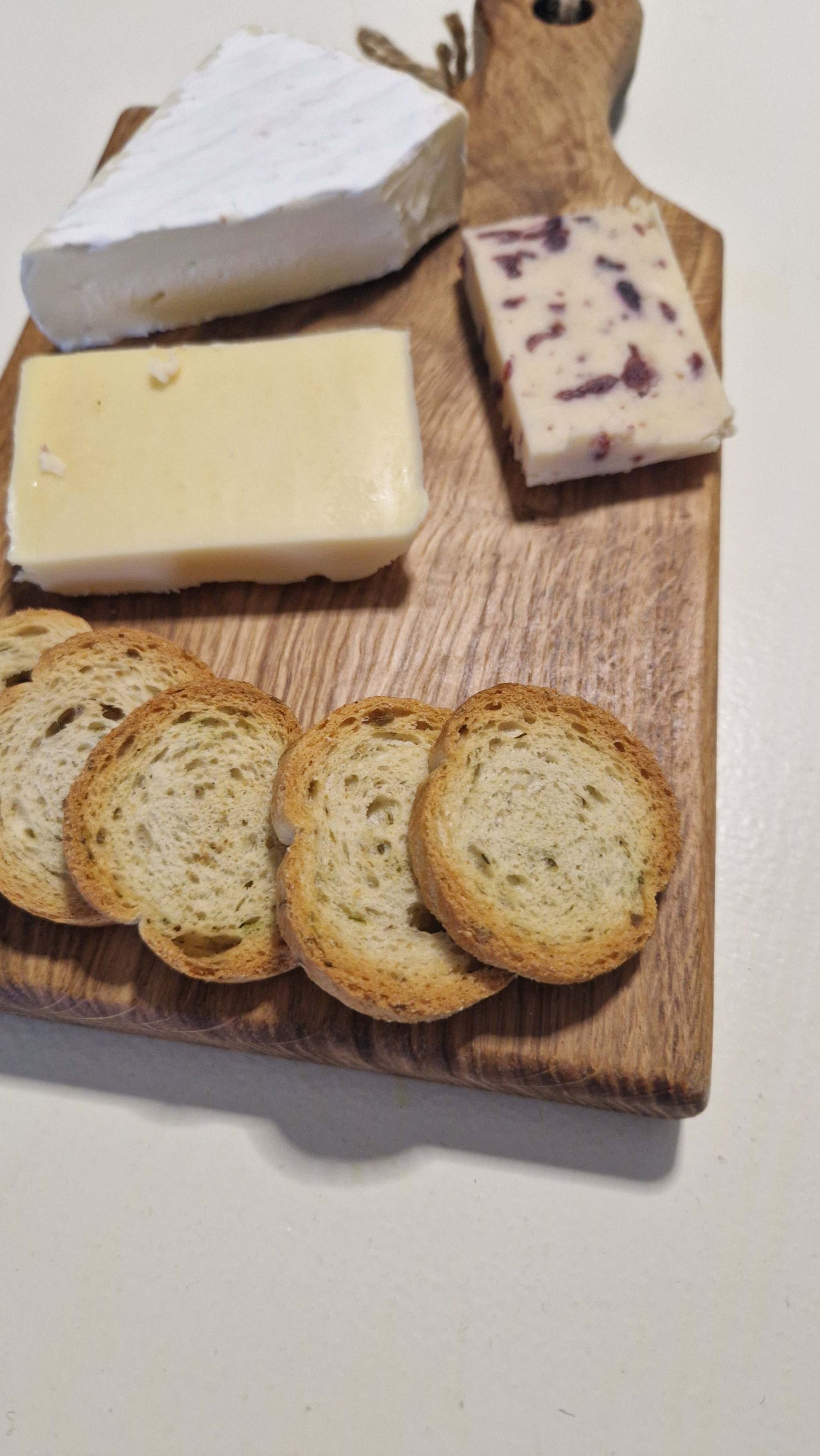 Handmade charcuterie board with assorted cheeses and crackers.