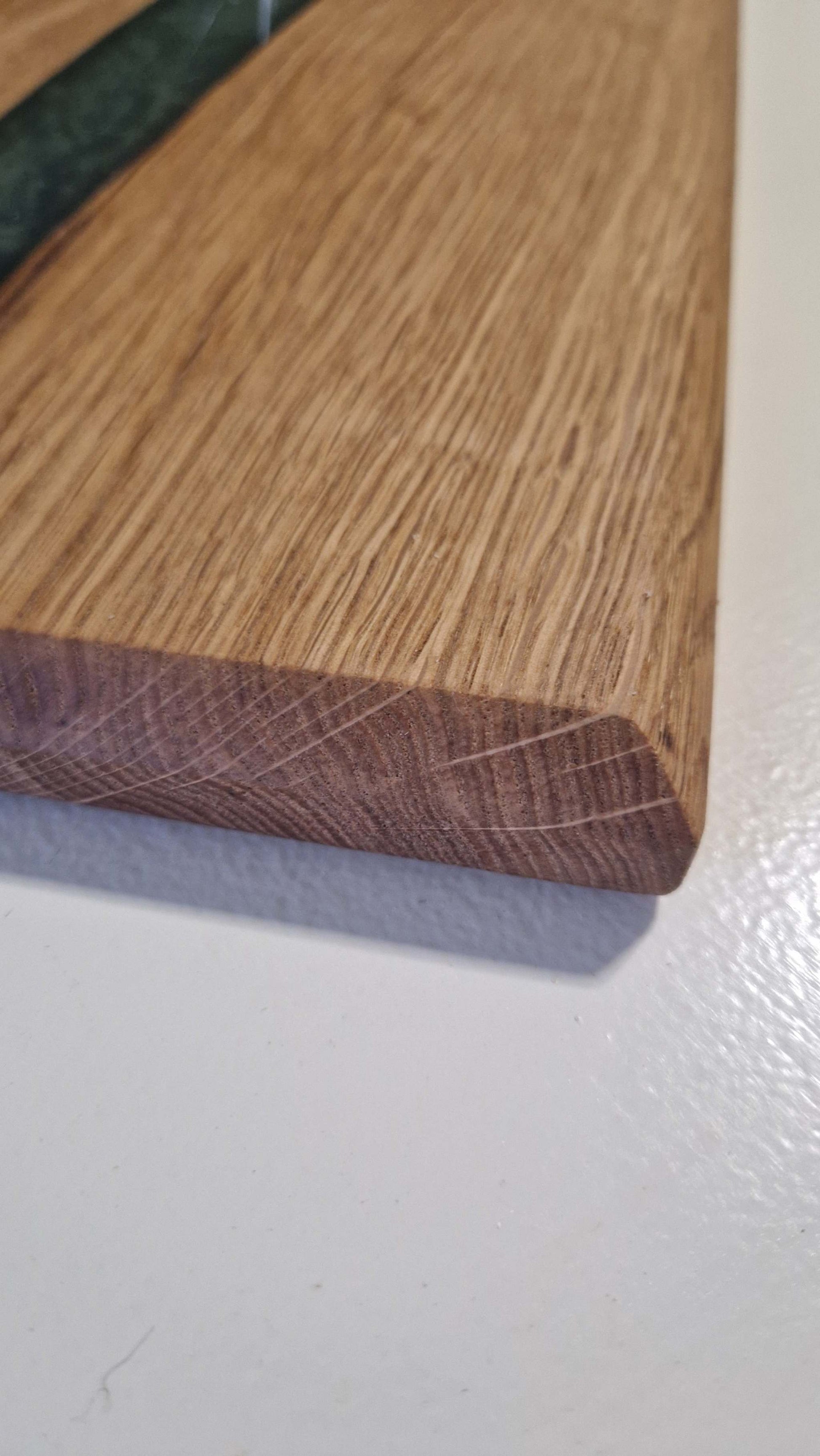 Handmade oak charcuterie board with green epoxy detail.