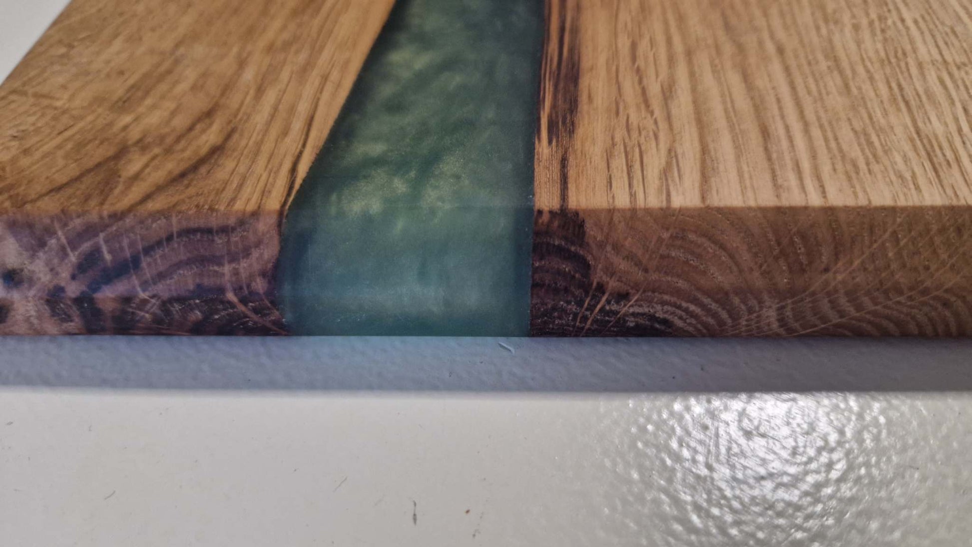 Handmade charcuterie board in oak with green epoxy detailing.