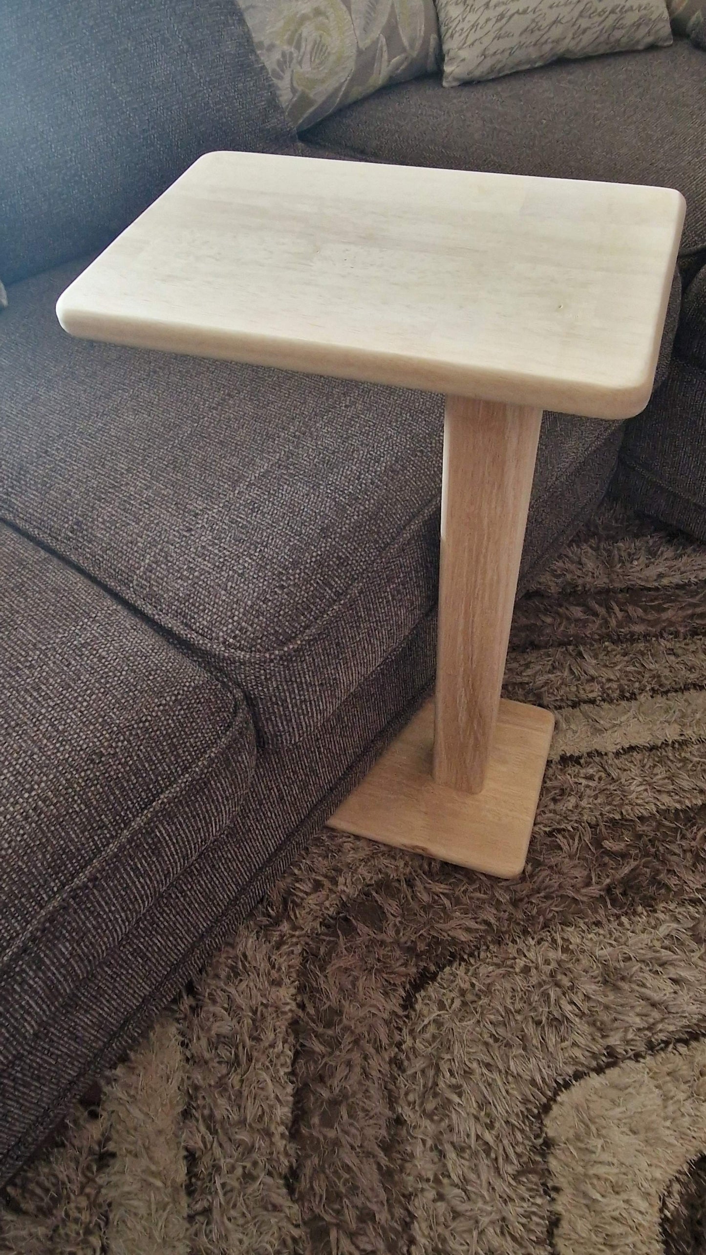 Handmade oak wooden couch table with sleek C-shape design.