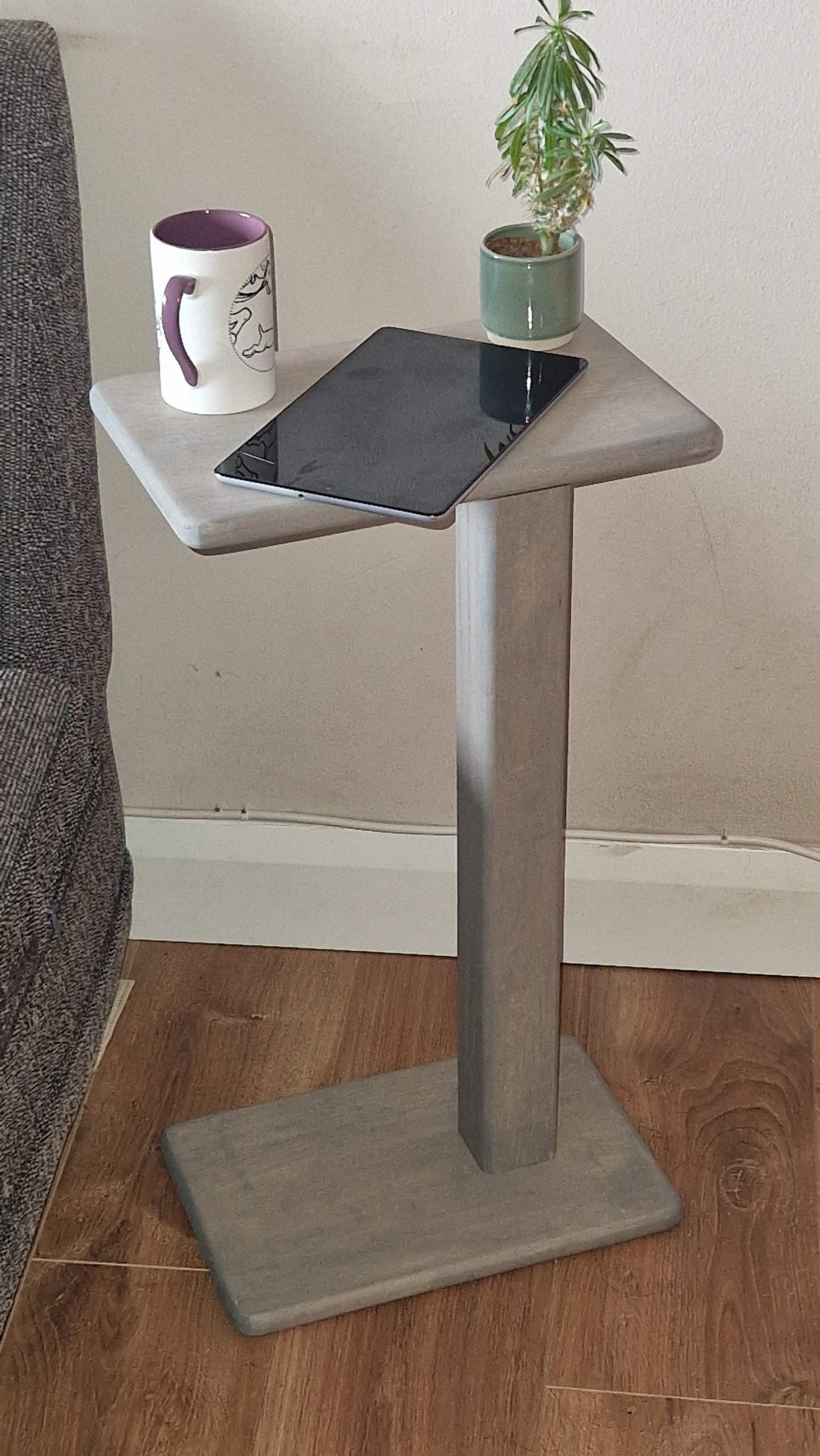 Handmade oak wooden couch table in grey with C-shape design, fitted for sofa or chair use, showcasing a mug and tablet.