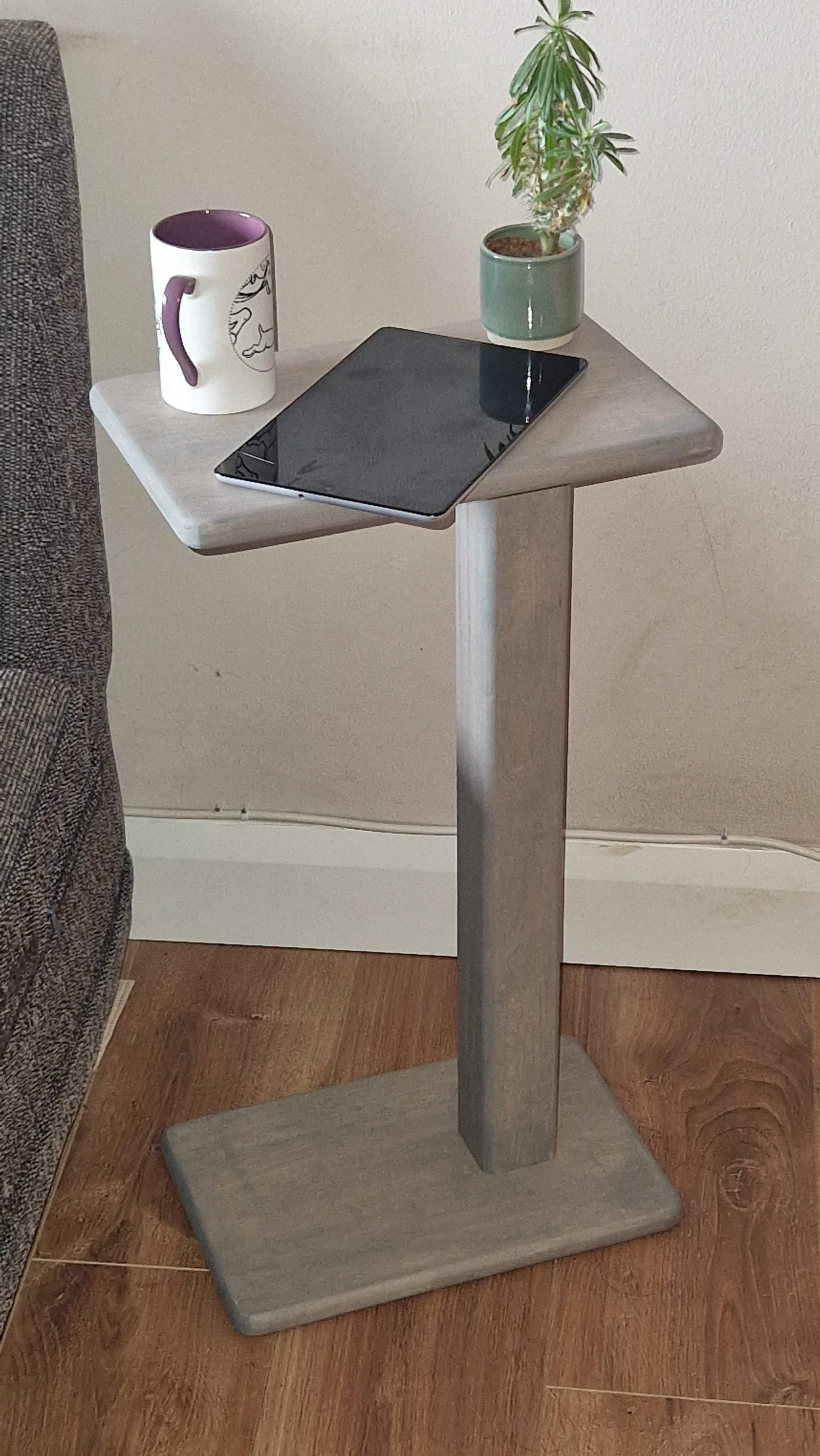 Handmade oak wooden couch table in grey with C-shape design, fitted for sofa or chair use, showcasing a mug and tablet.