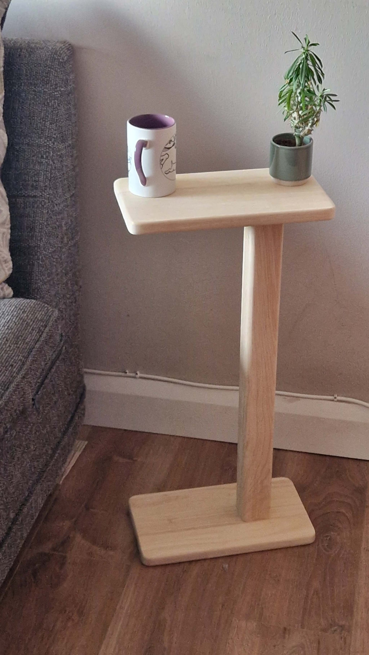 Handmade oak wooden couch table with a sleek C-shape design, perfect for modern and minimalist spaces.