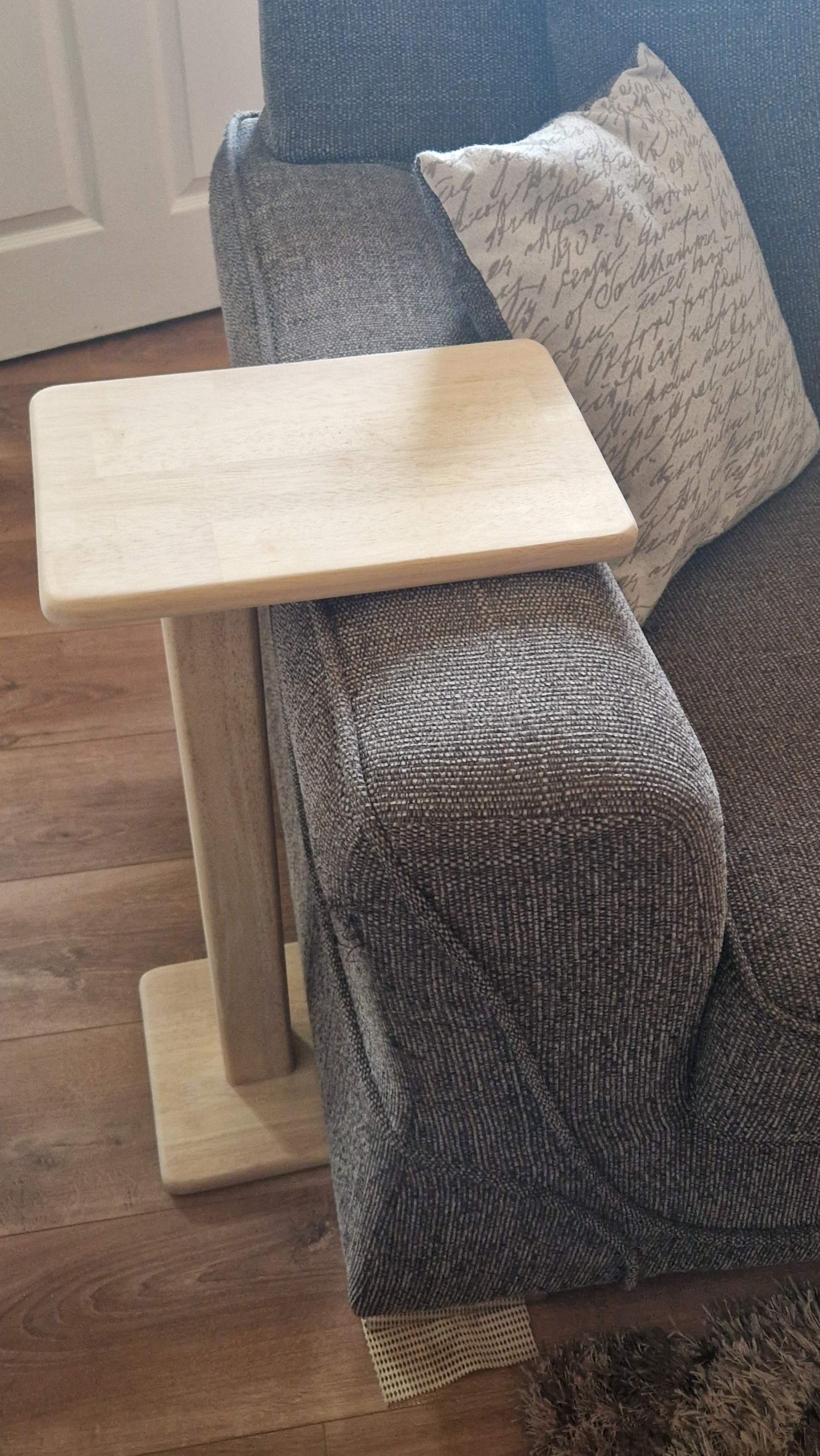 Handmade oak wooden couch table with a sleek C-shape design.