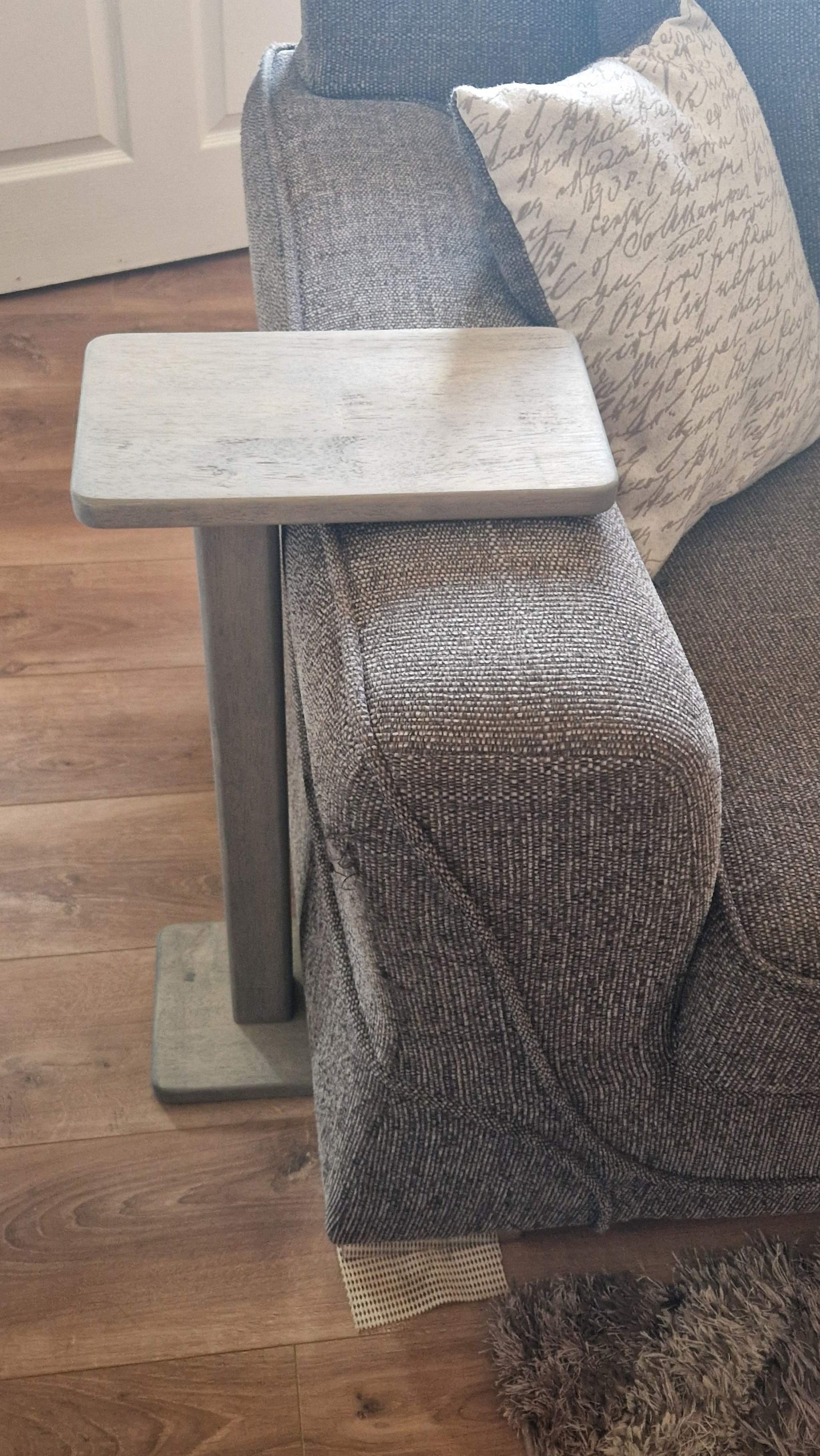 Handmade oak wooden couch table in grey, 35cm x 21cm, next to a sofa.