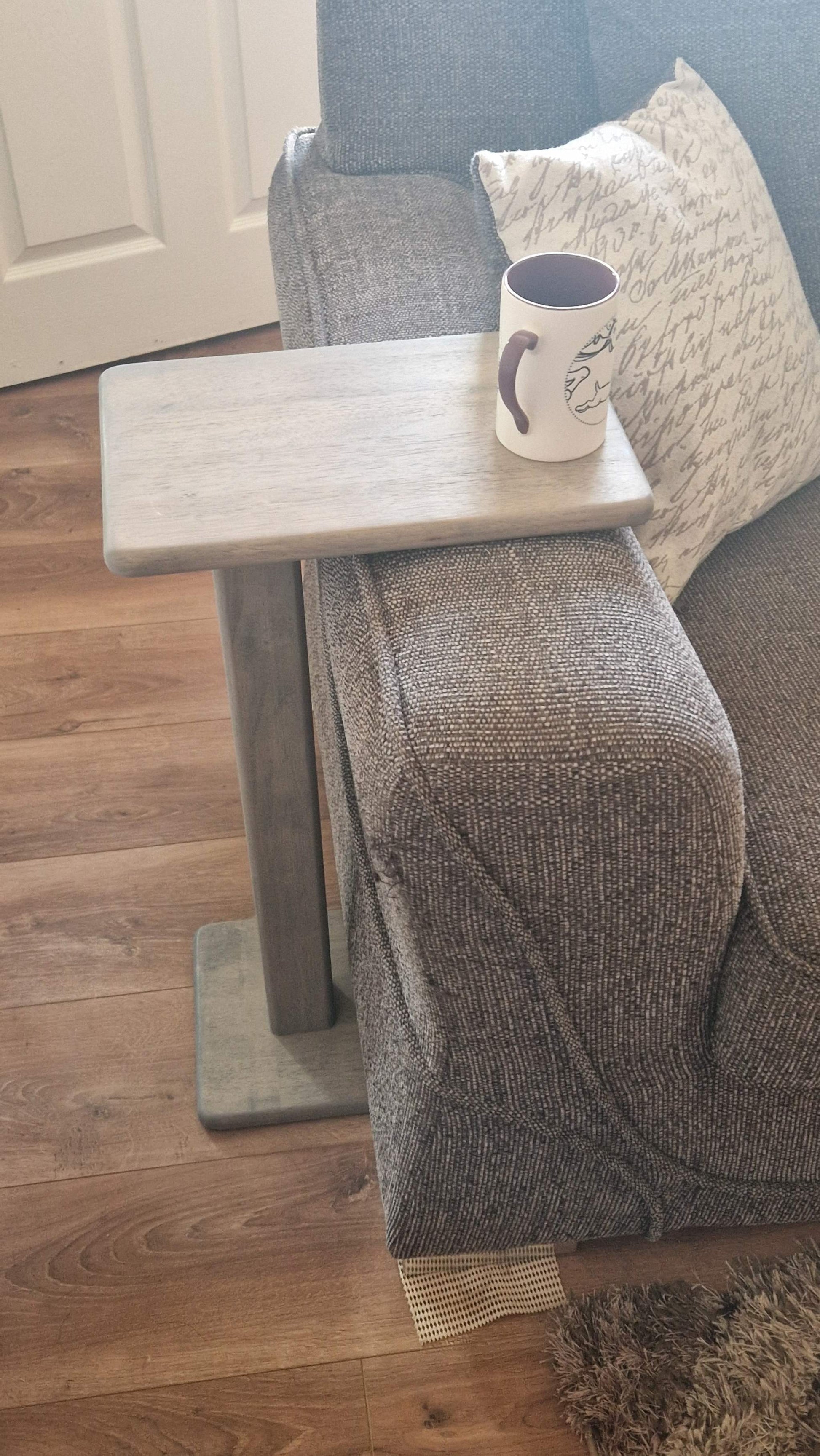 Handmade oak wooden couch table in grey, designed for use as a side table or laptop stand, with a sleek C-shape and epoxy details.