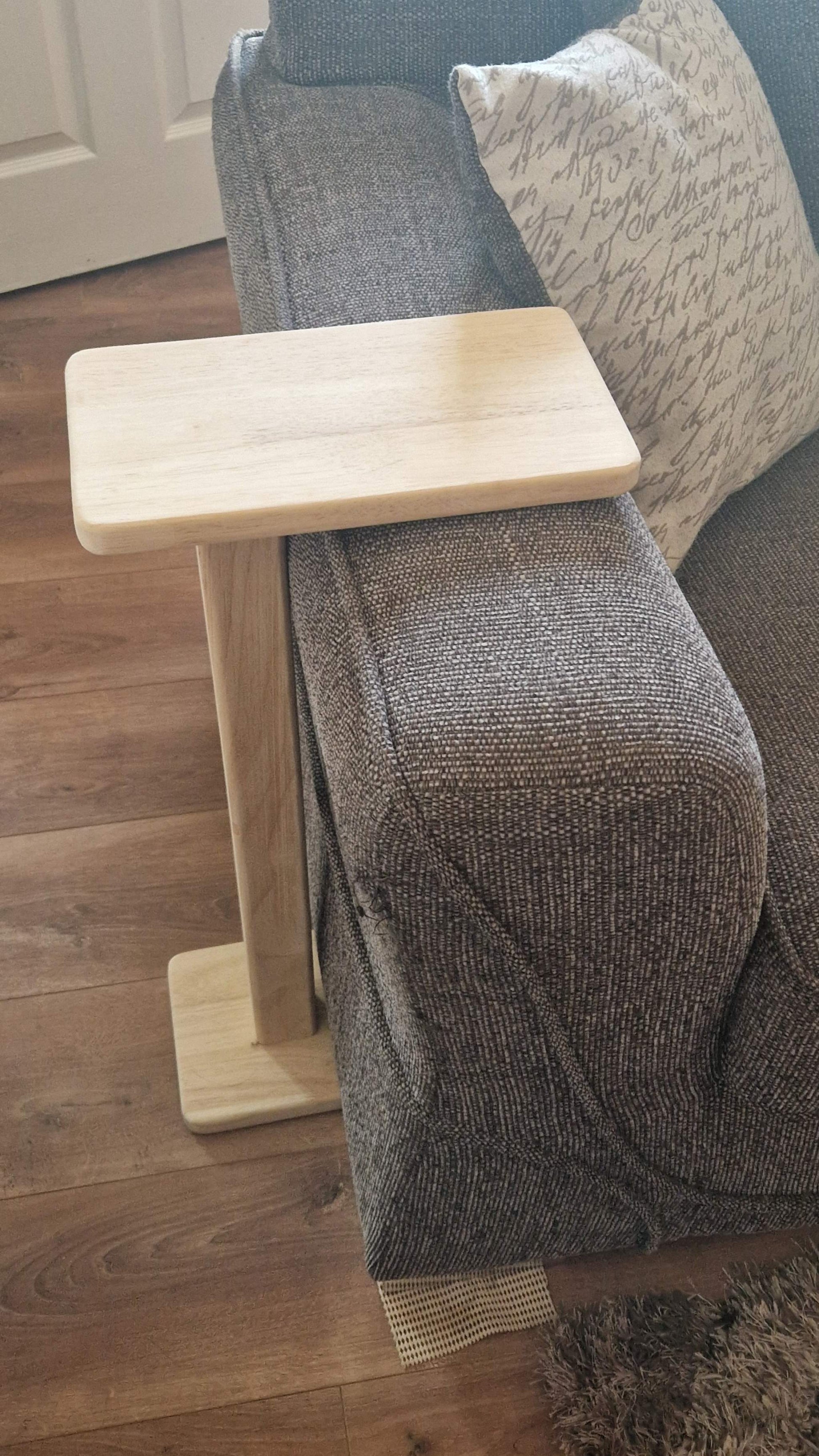 Handmade oak wooden couch table with C-shape design in living room setting.
