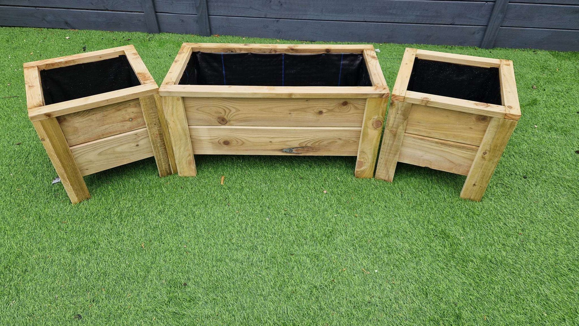 Handcrafted Wooden Planter Set with 1 large and 2 matching medium planters on green grass background.